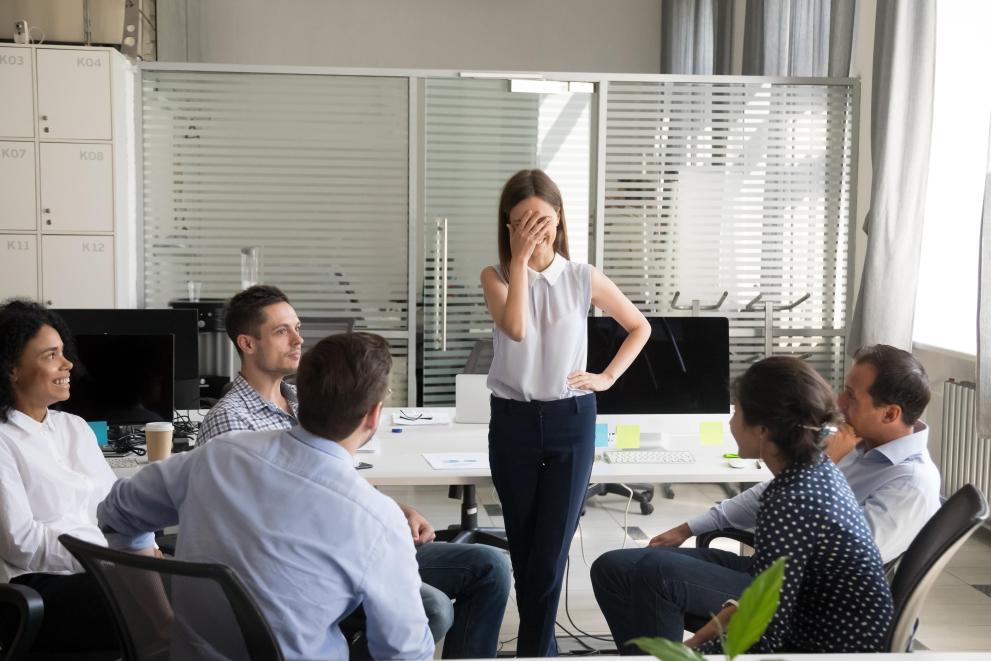 woman laughing amidst men in chairs